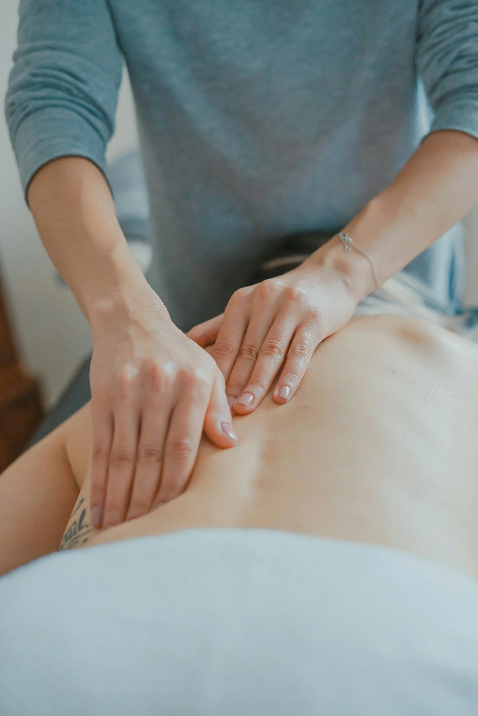 Massage therapist providing a back massage